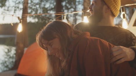 Joyous-Couple-Chatting-and-Laughing-at-Campsite